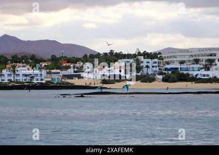 Corralejo, Canary island of Fuerteventura in Spain - November 25 2023: windsurfing in front of the coastline Stock Photo