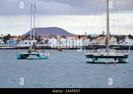 Corralejo, Canary island of Fuerteventura in Spain - November 25 2023: windsurfing in front of the coastline Stock Photo