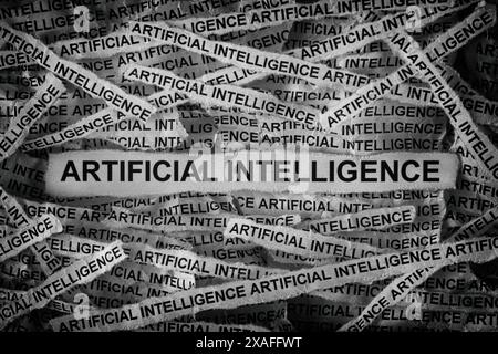 Strips of newspaper with the words Artificial Intelligence typed on them. Black and white. Close up. Stock Photo