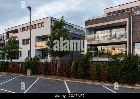 Merchtem, Flemish Brabant - Belgium - 09 12 2021: View over contemporary residential apartment blocks and a parking lot Stock Photo