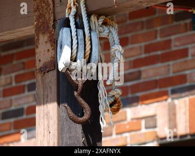 Rusty old fishing hook in the front of a home in a marine setting. Stock Photo