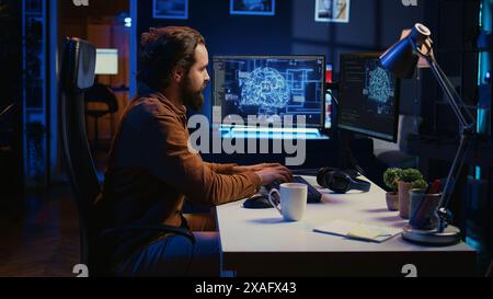 Computer scientist writes code on PC to visualize artificial intelligence neural networks. Remote IT worker runs AI script for information processing from personal office, camera B Stock Photo