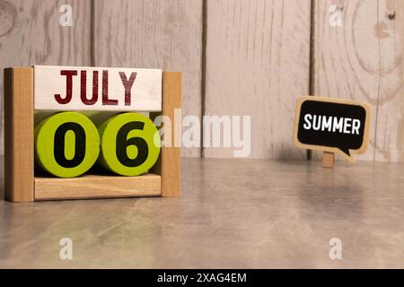 July 6 calendar date text on wooden blocks with blurred background park. Copy space and calendar concept Stock Photo