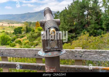 A vintage public coin operated telescope on a observation deck Stock Photo