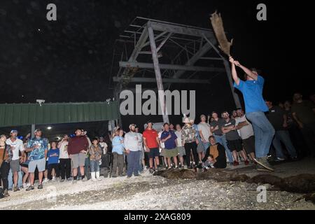 Participant hurls a dead nutria in the 'nutria toss' contest at the annual Nutria Rodeo in Louisiana, which promotes hunting the invasive rodent. Stock Photo