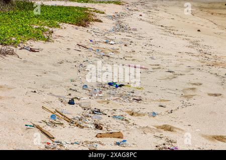Plastic bottles and other trash washed up on a tropical beach in Lombok Stock Photo
