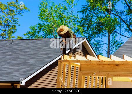 When cutting beams during construction, contractor uses cordless reciprocating saw Stock Photo