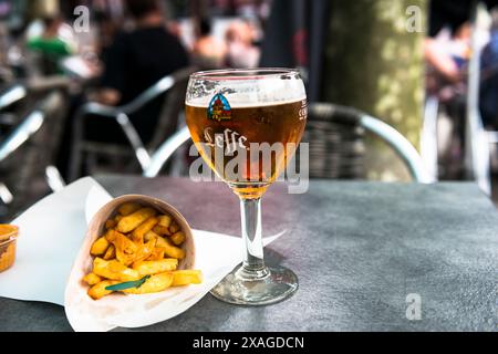 Draft Leffe blond beer with Belgian frites. Brussels, Belgium. Stock Photo
