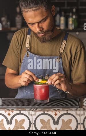 Drinks in a bar and barman Stock Photo