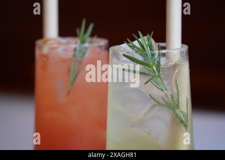 Refreshing summer cocktails with ice and rosemary on the table Stock Photo