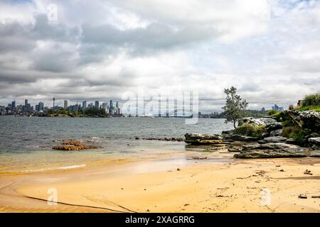 Milk Beach in Vaucluse Sydney eastern suburbs, small secluded harbour beach with view of Sydney city centre and Sydney harbour bridge,NSW,Australia Stock Photo