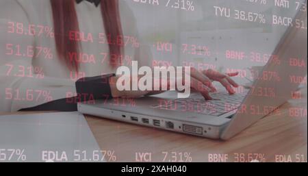 A red-haired hipster using a laptop at work Stock Photo