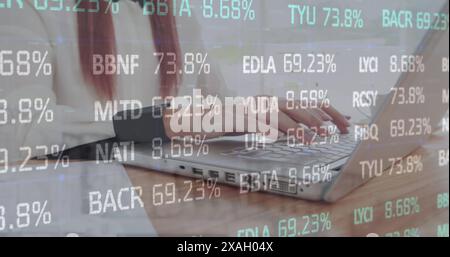 Image of stock market data processing against mid section of a woman using laptop Stock Photo