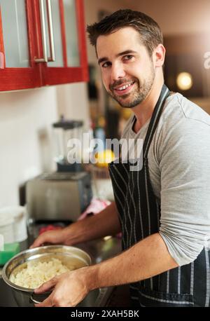 Man, pot and cooking food in home for dinner or eating on kitchen counter with portrait and rice. Male person, smile and meal prep for supper Stock Photo