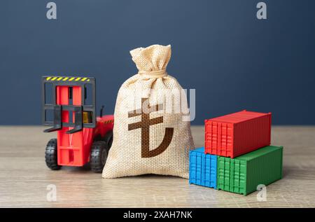 Forklift with shipping containers and turkish lira money bag. Import or export. Trade, economics and transport industry. Tariffs and tax collections. Stock Photo