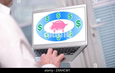 Saving money concept shown on a laptop used by a man Stock Photo