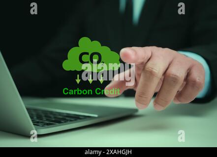 Carbon credit market concept. Businessman uses technology to exchange carbon credits, Carbon etf to invest in sustainable business, green climate fund Stock Photo