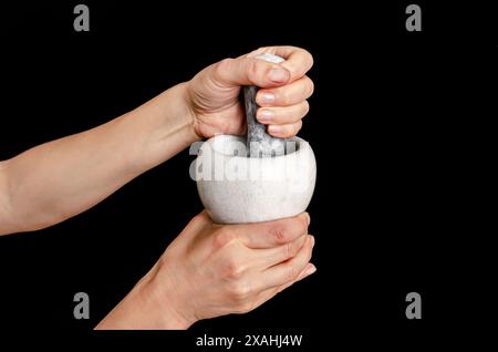 Close up of a pharmacist using mortar and pestle in the pharmacy Stock Photo