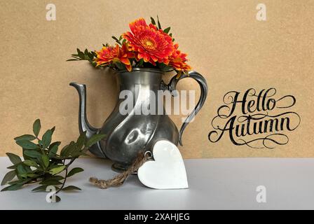 Vintage Teapot with Autumn Flowers and Decorative Heart on Rustic Background Stock Photo