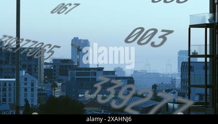 Image of numbers and data processing over cityscape Stock Photo