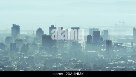 Image of multiple changing numbers floating against aerial view of cityscape Stock Photo
