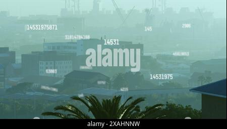Image of numbers and data processing over cityscape Stock Photo