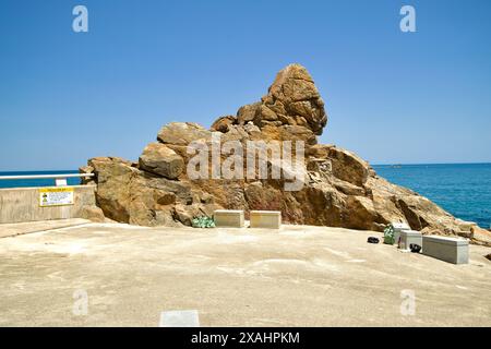 Samcheok City, South Korea - May 18th, 2024: Isabu Lion Rock, a prominent rock formation along the Samcheok coastline, stands majestically by the clea Stock Photo