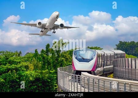 View railway track suburban subway electric train rushing surrounded green trees park. Passenger plane flying in clouds sky, take off landing airport. Stock Photo