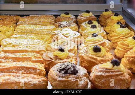 Assorted Pastries with Chocolate, Cream and Fruit on Exhibition inside a Pastry Shop. Stock Photo