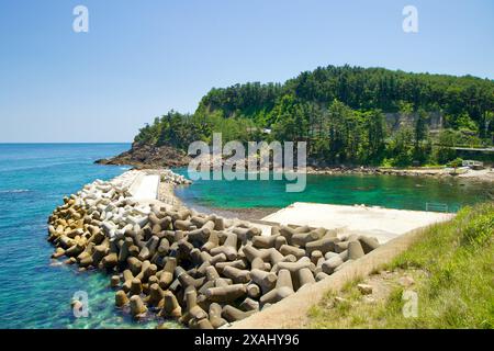 Samcheok City, South Korea - May 18th, 2024: The stunning turquoise waters and rocky coastline along Isabu Road, with a protective breakwater. The lus Stock Photo