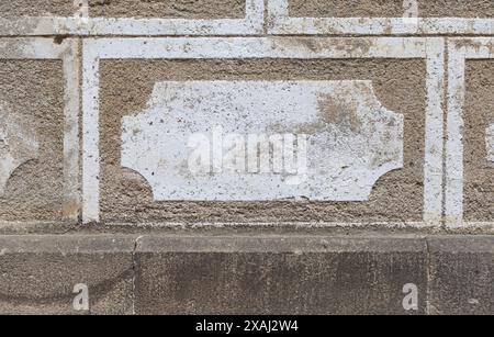 close-up flat photography of an old stone wall texture with white details on beige background Stock Photo