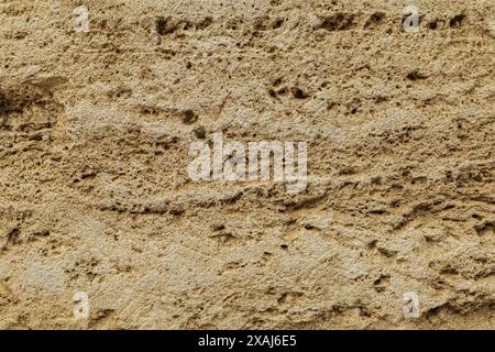 close-up flat photography of a beige yellow sandstone surface, ancient rough sand rock textured background Stock Photo