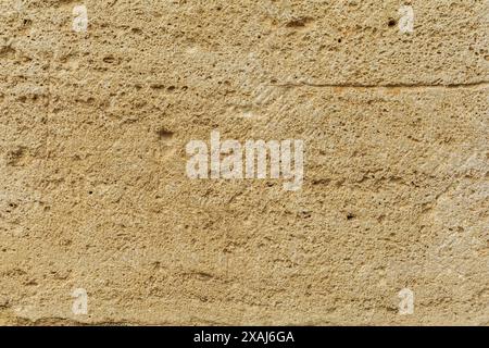 close-up flat photography of a beige yellow sandstone surface, ancient sand rock textured background Stock Photo
