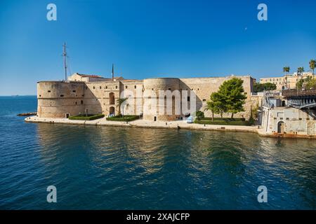 Aragonese Castle of Taranto and revolving bridge on the channel between Big and Small sea, Puglia, Italy, Blue sunny sky Stock Photo