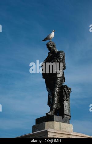 Meditative Ovid statue with seagull on his head in the Ovid Square, Old Town of ancient Tomis, Constanta city, Romania. Black and white image. Stock Photo