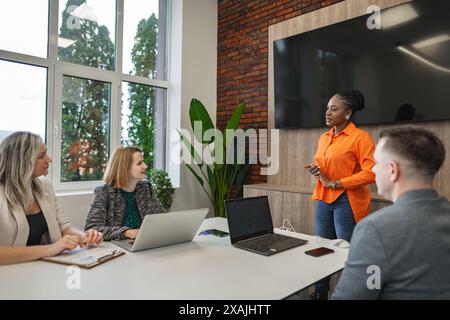 Group of People Sitting Around Table With Laptops Stock Photo
