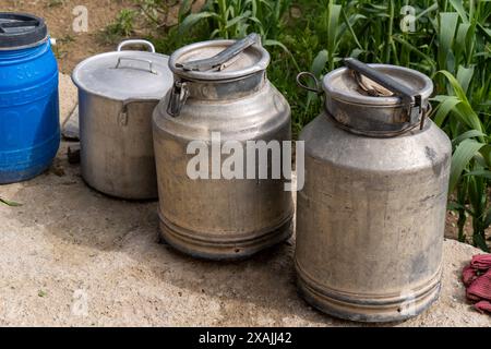 Three old metal cans are stacked on top of each other Stock Photo