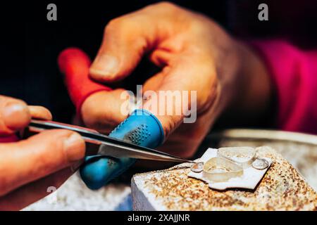 Close up of jewelers hands in process of soldering fine silver Stock Photo