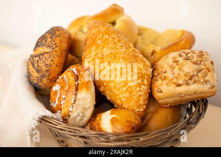 delightful assortment of freshly homemade baked pastries, including cheese buns, poppy seed buns, rolls, savory pretzels and sweet curd tarts in tradi Stock Photo