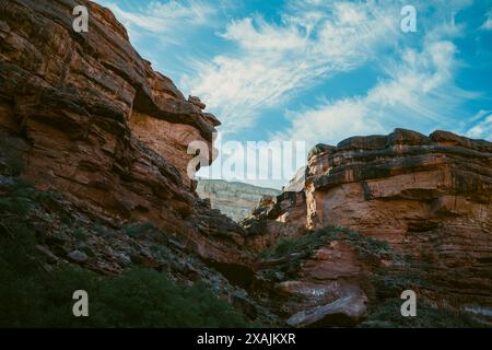 Dramatic clouds hang over sparse canyons in Arizona at sunrise. Stock Photo