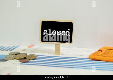 Close up of a closed sign hanging in the window of a store. Stock Photo