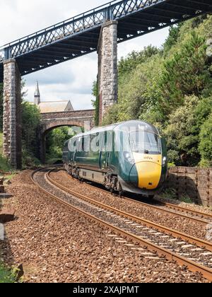 Teignmouth, England – July 21, 2023: A Hitachi class 800 series train of the Great Western Railway passenger service leaving town Stock Photo
