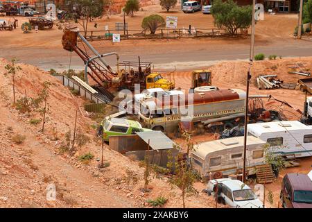 Old blower truck in a junkyard of rusty abandoned vintage cars in the desert of the Australian outback of the red center in the opal mining town of Co Stock Photo