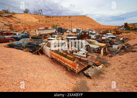 Junkyard of rusty abandoned vintage cars in the desert of the Australian outback of the red center in the opal mining town of Coober Pedy, South Austr Stock Photo