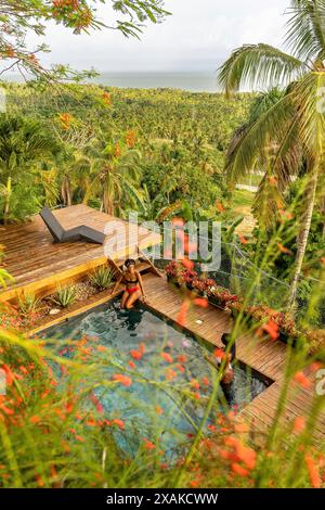 North America, Caribbean, Hispaniola Island, Dominican Republic, Samana Peninsula, Sanchez, Jardines La Loma, Two pretty Latinas in the pool Stock Photo