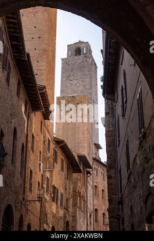 In the streets of San Gimignano, view on the towers Rognosa, Pettini and Chigi - Italy Stock Photo