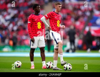 England's Kobbie Mainoo (left) and Cole Palmer warming up before the international friendly match at Wembley Stadium, London. Picture date: Friday June 7, 2024. Stock Photo