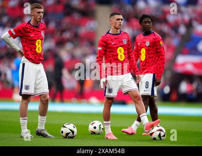 Left to right, England's Cole Palmer, Phil Foden and Kobbie Mainoo warming up before the international friendly match at Wembley Stadium, London. Picture date: Friday June 7, 2024. Stock Photo