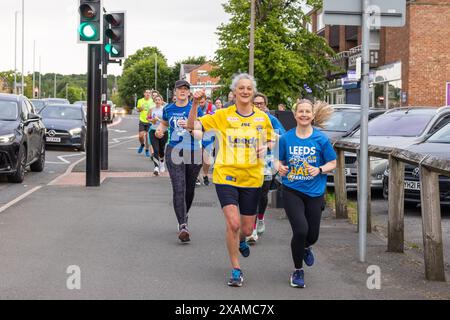 Leeds, UK. 07 JUN, 2024. Runners pose to camera as they take part in 7 mile route, shaped like a rhino, through the streets of Moor town in honour of Leeds Rhinos legend number 7 Rob Burrow, who passed away on Sunday aged 41 following an over 4 year battle with motor neurone disease (MND). Credit Milo Chandler/Alamy Live News Stock Photo