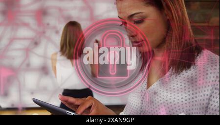 Image of padlock in circles and navigation pattern over biracial woman using tablet Stock Photo